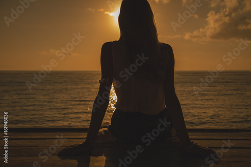 Girl enjoying the ocean tropical sunset / sunrise.