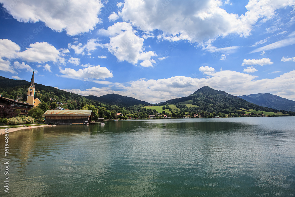 Idyllic mountain landscape in the Alps with lake, green meadows and mountains Idyllic mountain landscape in the Alps with lake, green meadows and mountains