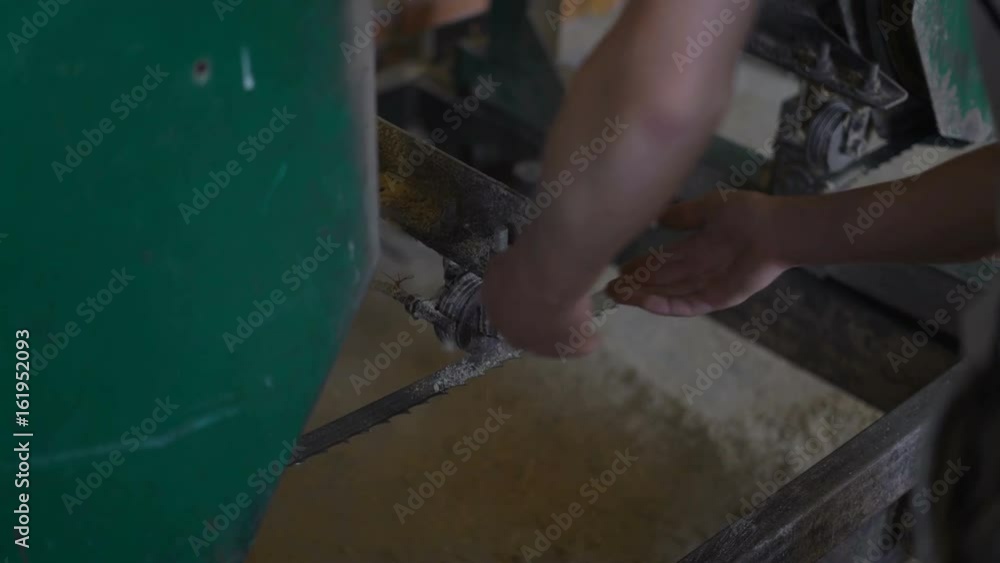 a Worker Cleans Debris From a Long Video at the Sawmill a Worker Cleans Debris From a Long Video at the Sawmill