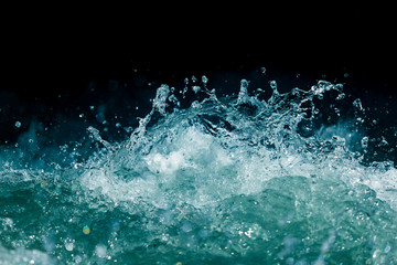 Splash of stormy water in the ocean on a black background
