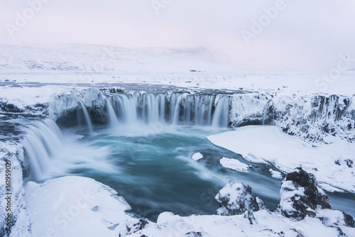 Beautiful winter Godafoss waterfall in Iceland  covered in snow  long exposure