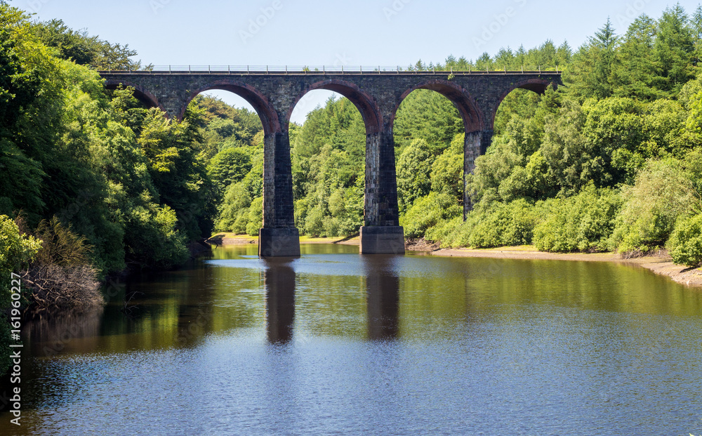 Old railway viaduct over Wayoh Reservoir on a beautiful summers afternoon, Bolton, Gtr Manchester, UK