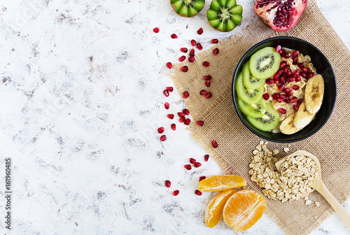 Wallpaper Mural Healthy breakfast. Oatmeal with fruit on white background. Top view Torontodigital.ca