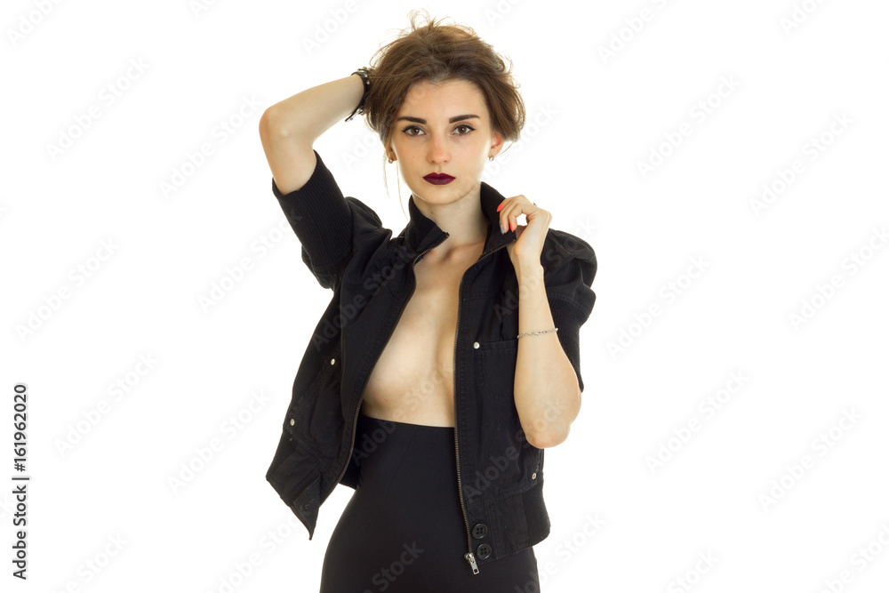 Sexy lady with beautiful silicon breasts in black jacket looks at the camera Sexy lady with beautiful silicon breasts in black jacket looks at the camera