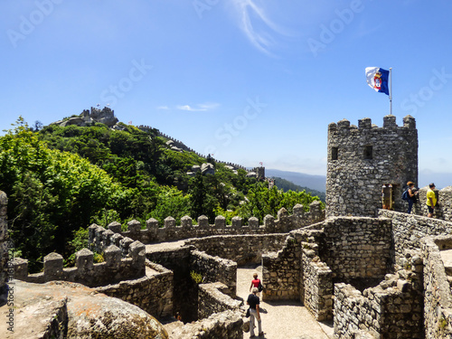 Walls of the Moorish Castle and Pena Palace in the background in Sintra, Portugal photo