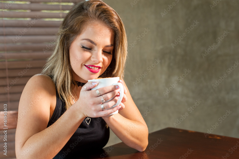 attractive woman drinking a hot beverage attractive woman drinking a hot beverage