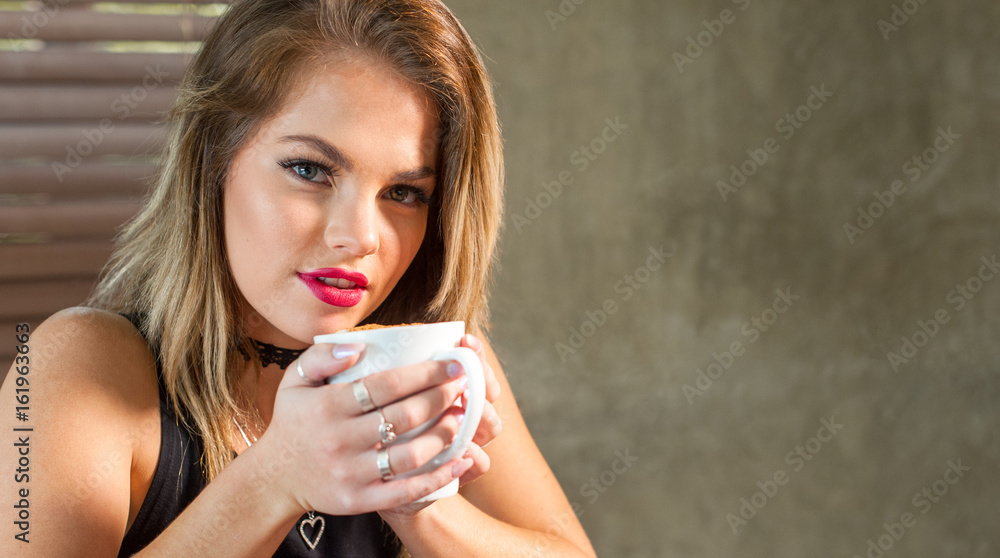 attractive woman drinking a hot beverage attractive woman drinking a hot beverage