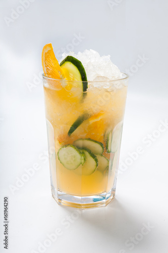 glass with orange cucumber refreshing drink, rustic style, selective focus