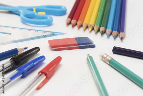 Different Kind of Colorful School and Office Utensils Arranged on a White Surface