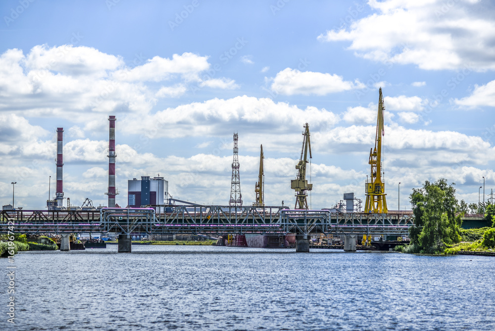 Landscape of industrial Szczecin in Poland. River, craines, bridge.