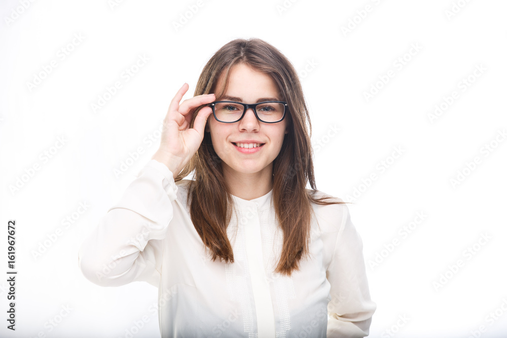 Beautiful young girl in glasses with a black rim a white shirt on an isolated background. Business concept Beautiful young girl in glasses with a black rim a white shirt on an isolated background. Business concept