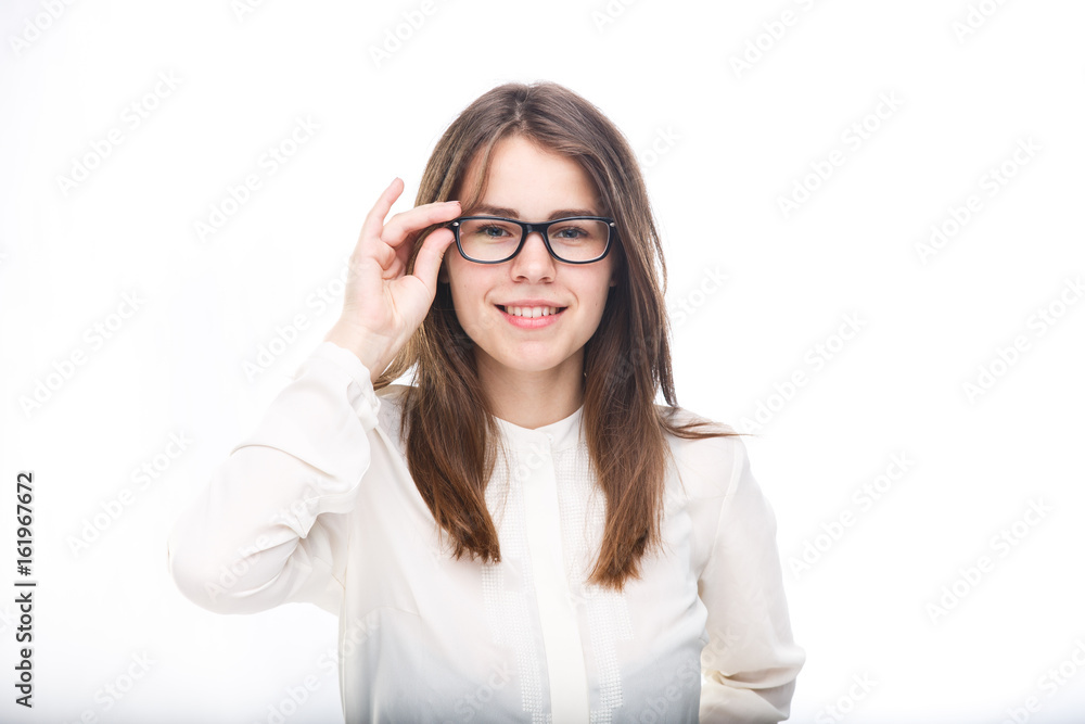 Beautiful young girl in glasses with a black rim a white shirt on an isolated background. Business concept