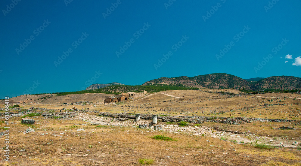 Ruins and old buildings in Hierapolis ancient city adjacent to modern Pamukkale in Turkey
