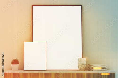 Two vertical posters on a closet, white toned