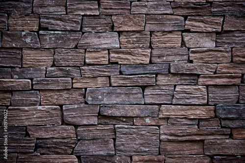 It is Dark brown brick wall for pattern.