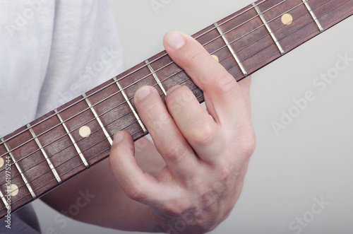 hand on a guitar fingerboard