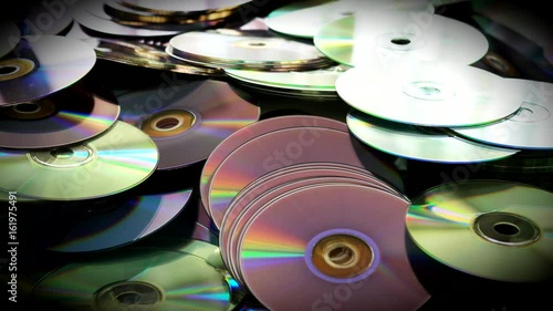 Compact Cds and Dvds Discs Scattered on the Table