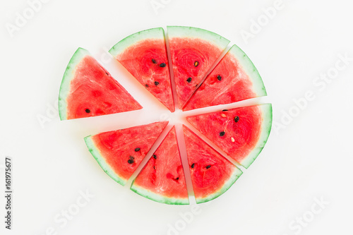 Slices of tasty watermelon on white background. Flat lay. Top view. Summer concept
