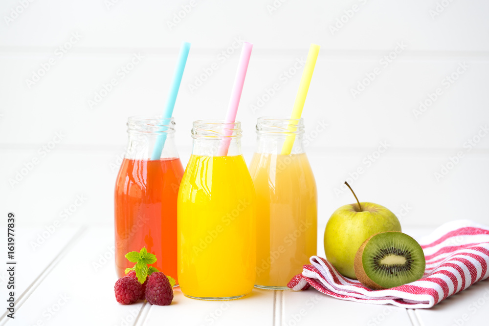 Collage of glasses with fresh delicious smoothie juice and straw on board background colourful for kids party