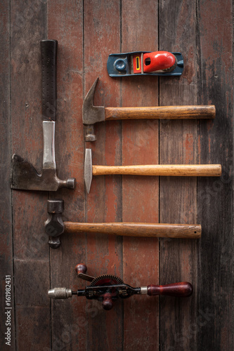 vintage carpenter tool on the old wood background 