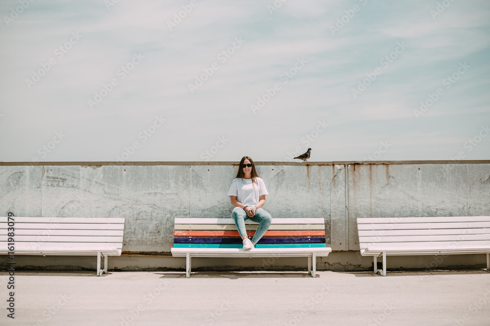 Beautiful woman on the beach with a mobile and a bird Beautiful woman on the beach with a mobile and a bird