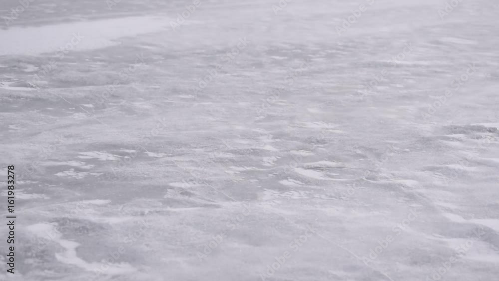 Drift snow on ice in winter blown diagonally by heavy wind Drift snow on ice in winter blown diagonally by heavy wind