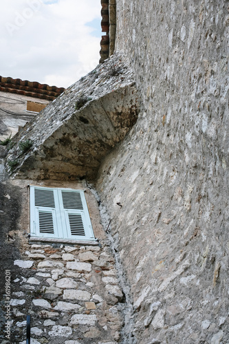 window in wall of medieval house in town Eze photo