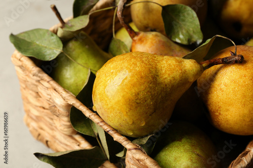 Fresh pears in wicker box closeup