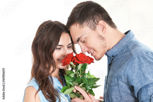 Beautiful couple with bouqu...