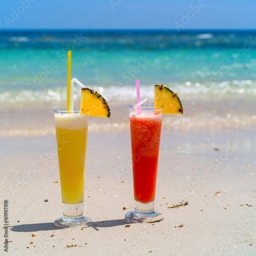 Colorful cool drink in summer on sea beach background