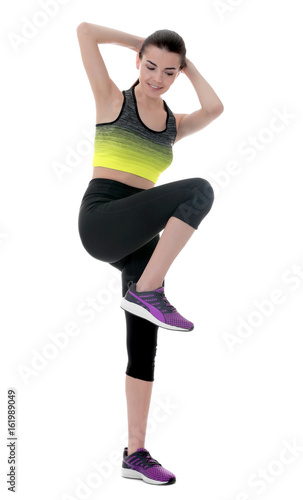 Beautiful woman doing bicycle crunch on white background