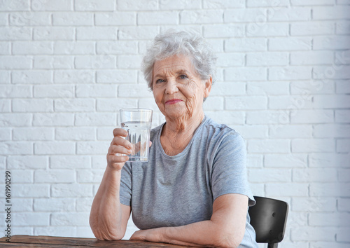 Elderly woman sitting and h...