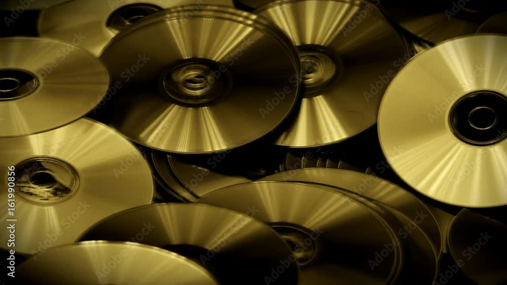 Golden Color Abstract Video of Cds and Dvds Disk Lie on the Table Golden Color Abstract Video of Cds and Dvds Disk Lie on the Table