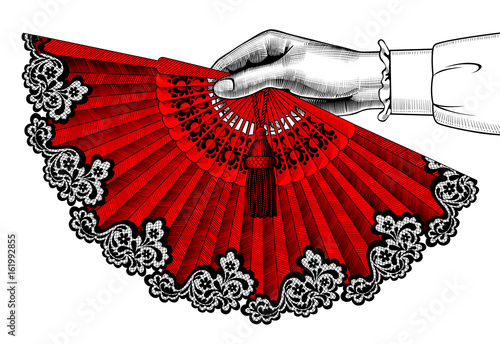 Female hand with red open fan