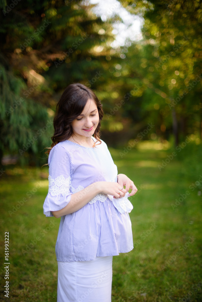 pregnant girl is walking around the city park pregnant girl is walking around the city park