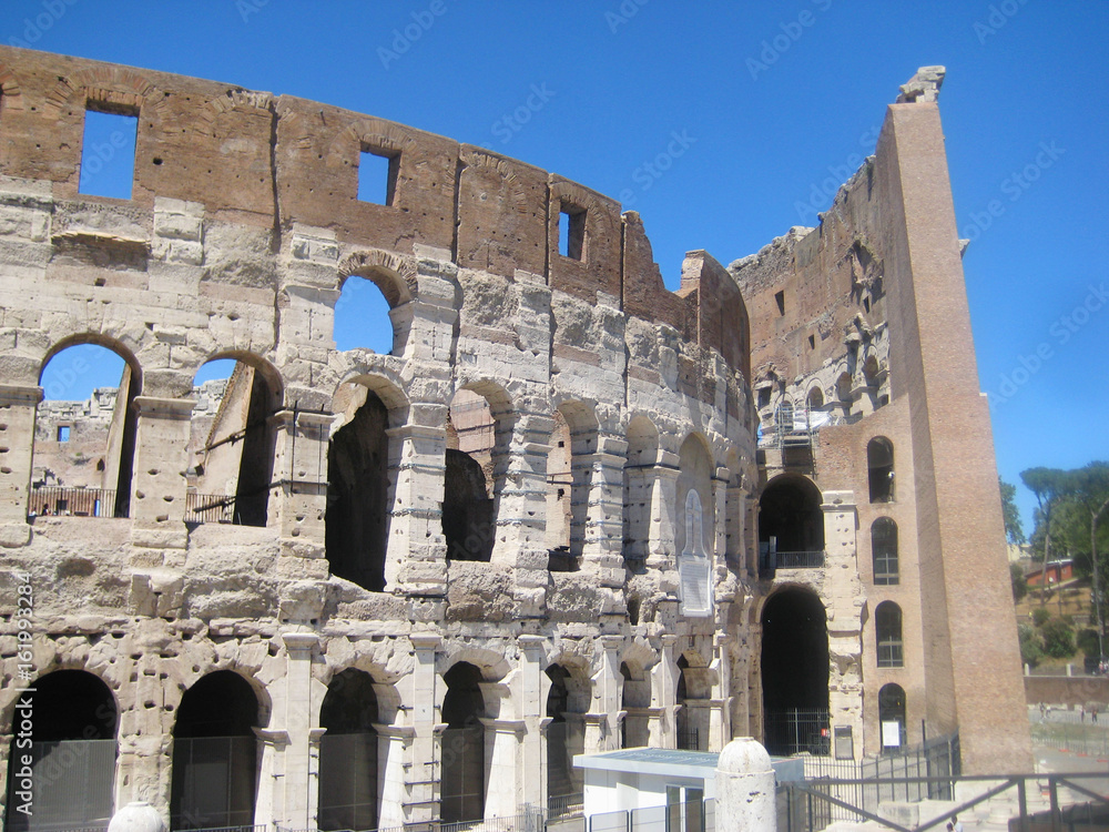 Colosseum or Coliseum (Flavian Amphitheatre) historic monument in Rome, Italy. World largest ancient amphitheatre built of concrete and sand. View of old fracture breaking walls