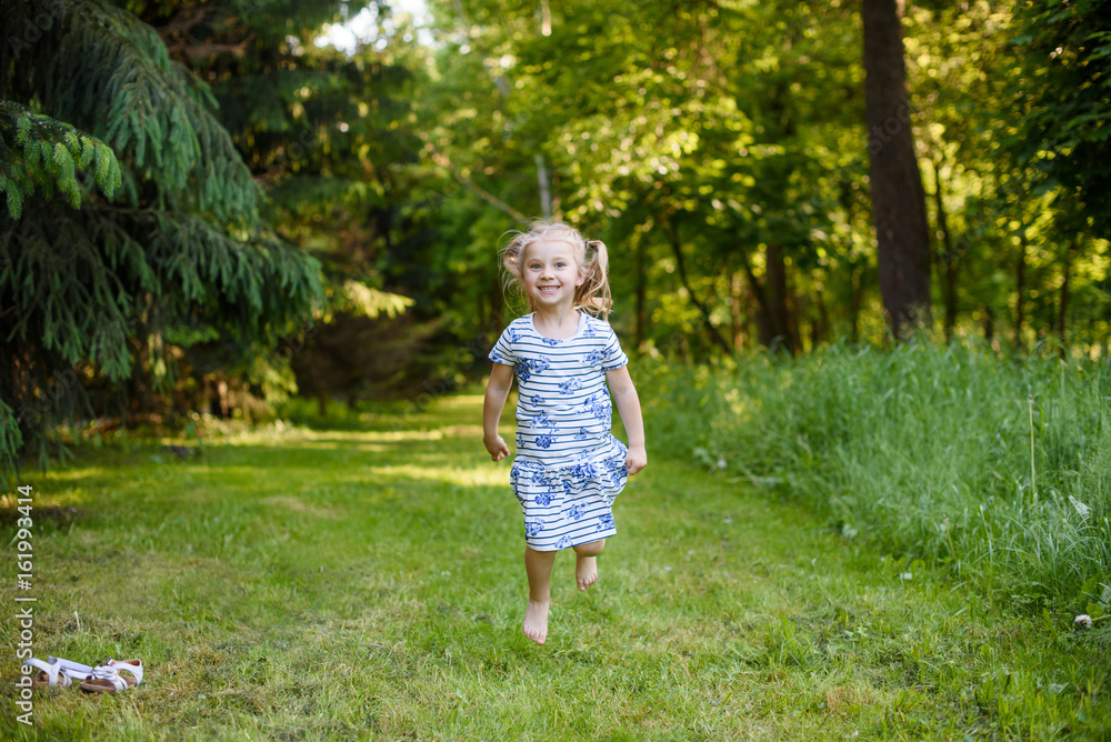 Happy smiling beautiful girl jump on green outdoor Happy smiling beautiful girl jump on green outdoor