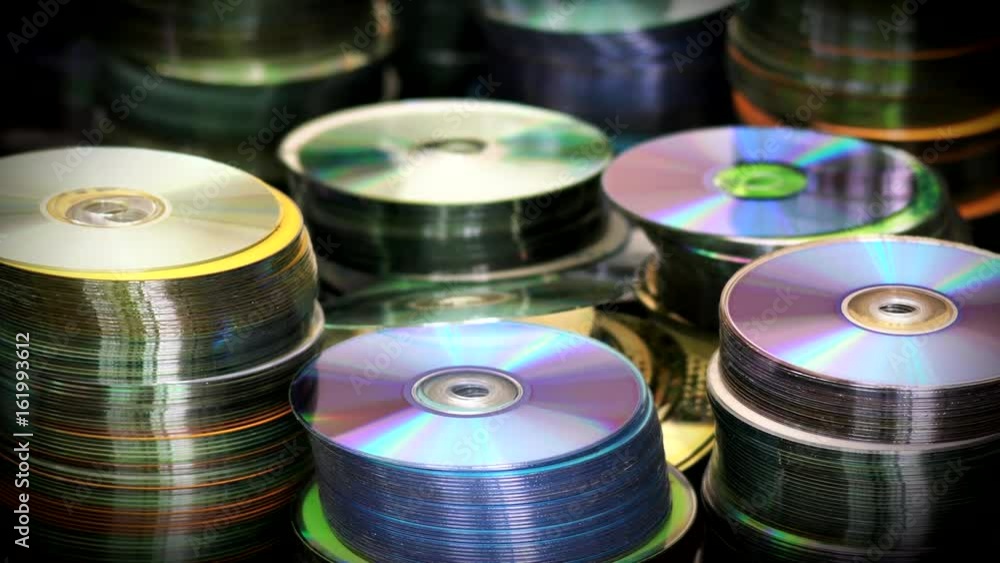 Blur View of Compact Optical Dvd or cd Discs Piles Standing on Table