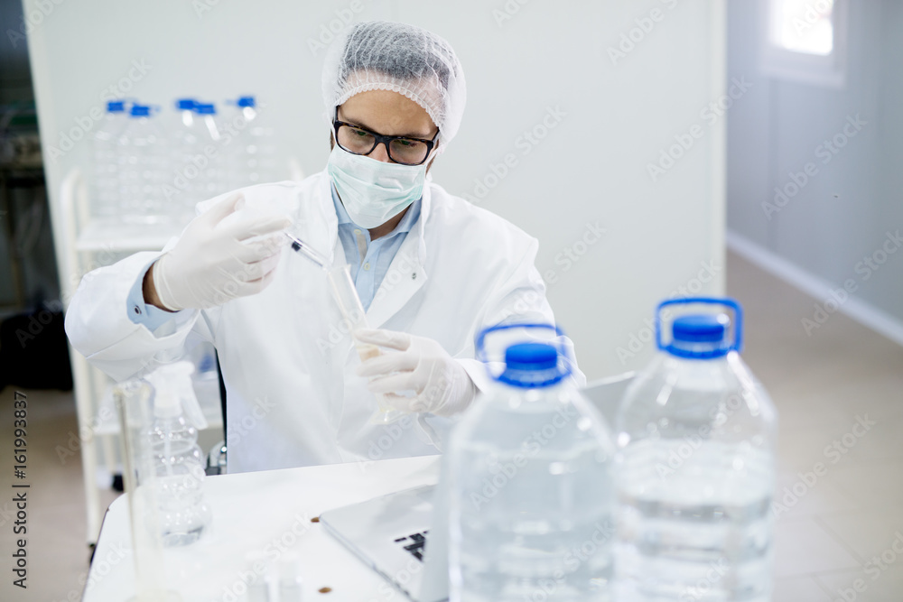 Lab technician doing chemical analysis. Testing chemical composition of the water. Lab technician doing chemical analysis. Testing chemical composition of the water.