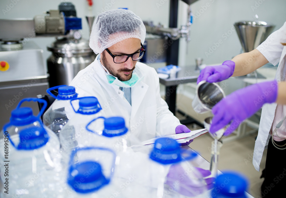 Lab technician doing chemical analysis. Testing chemical composition of the water. Lab technician doing chemical analysis. Testing chemical composition of the water.