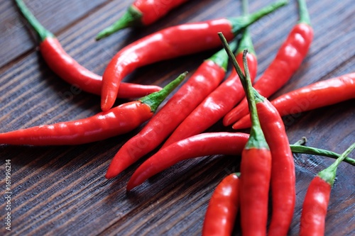 Red hot chile pepper on wood background