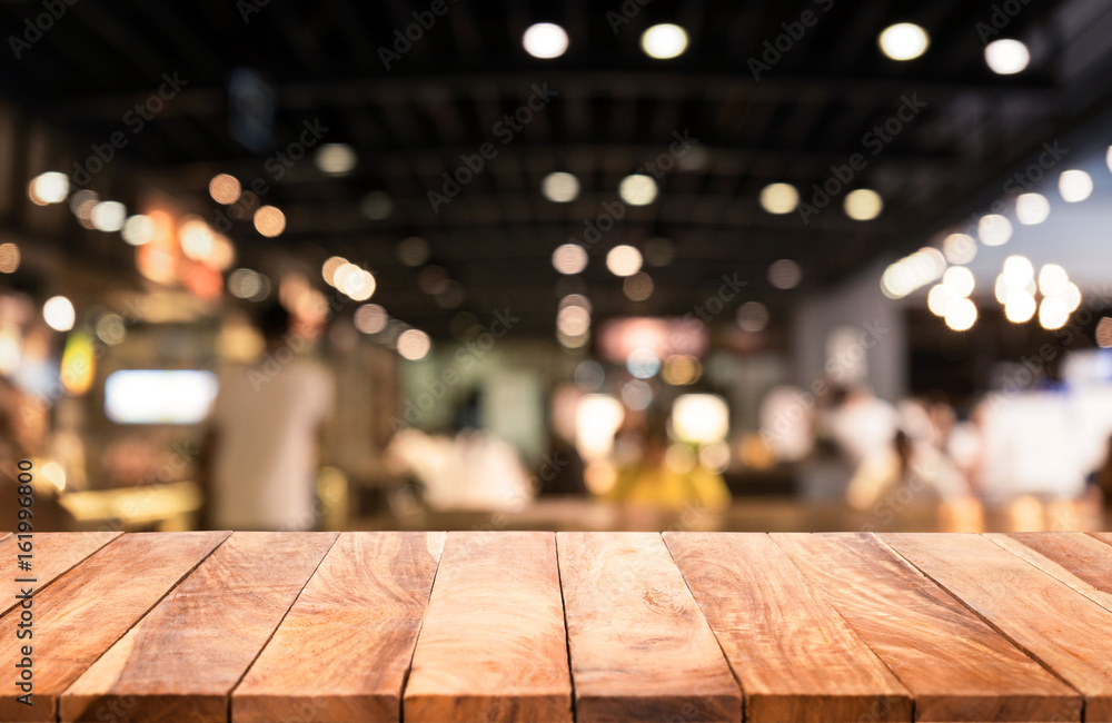 Wood table top with  blurred lights abstract background from cafe restaurant.For montage product display or key visual layout