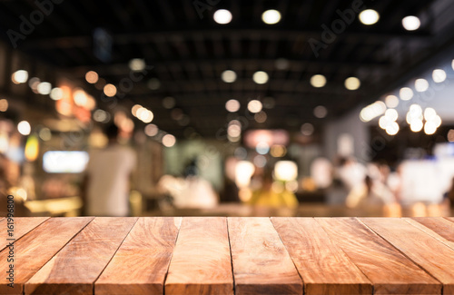 Wood table top with blurred lights abstract background from cafe restaurant.For montage product display or key visual layout