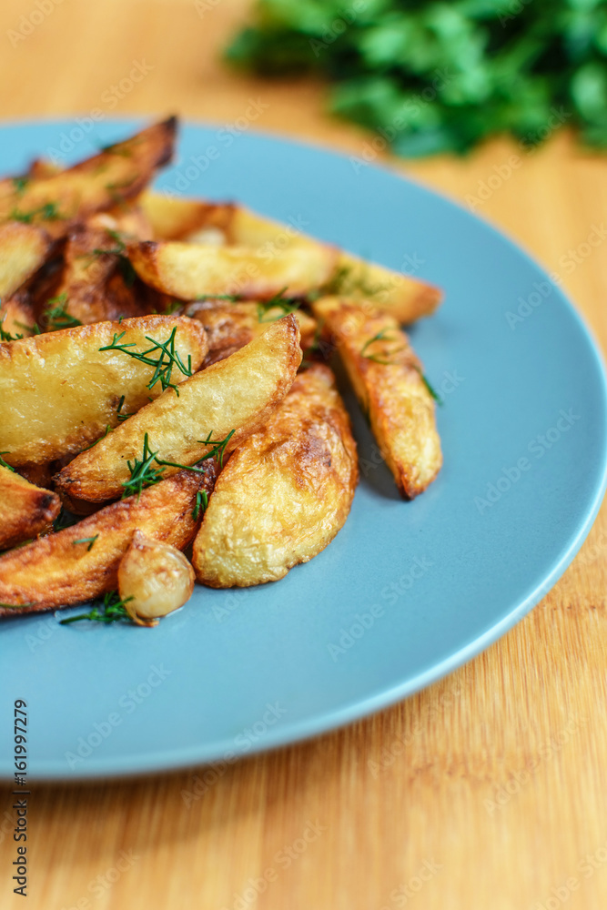 Roasted potatoes with salt pepper and cumin on wooden background Roasted potatoes with salt pepper and cumin on wooden background