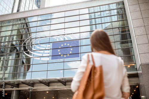 Young businesswoman standing back near the Parliament building of European Union in Brussel city