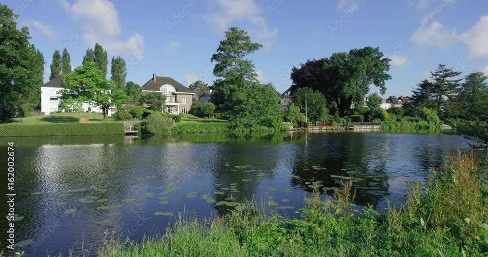 View of beautiful urban villas with river floating in the foreground View of beautiful urban villas with river floating in the foreground