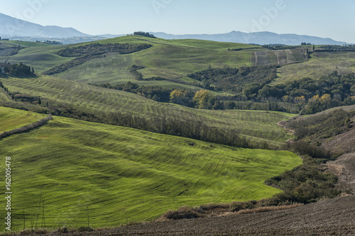 VAL D'ORCIA, TUSCANY-ITALY, OCTOBER 30, 2016: Scenic Tuscany landscape with rolling hills and valleys in Val D'Orcia, Italy in autumn
