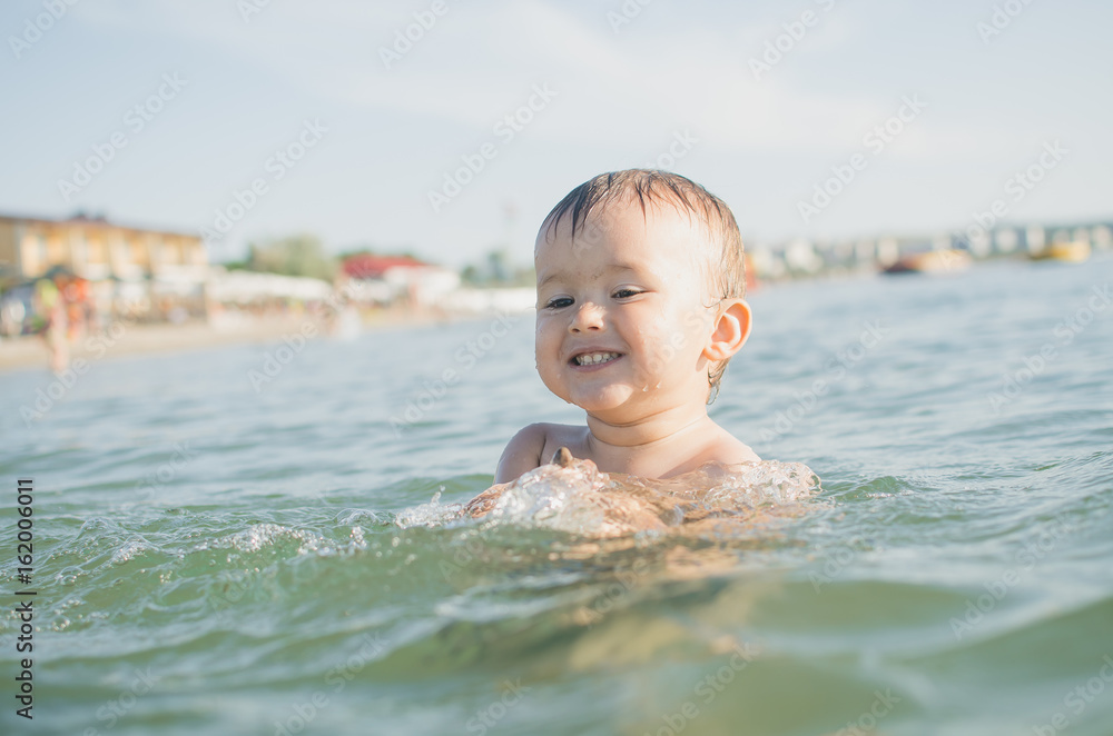 Little boy swimming in sea