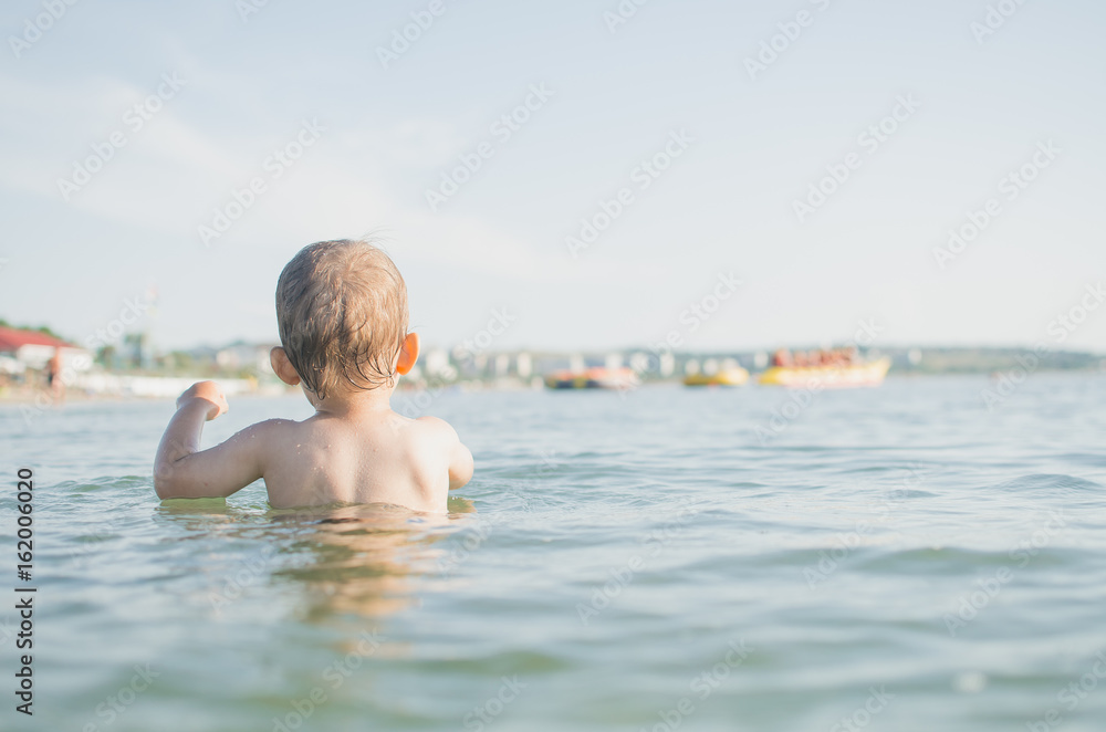 Little boy swimming in sea