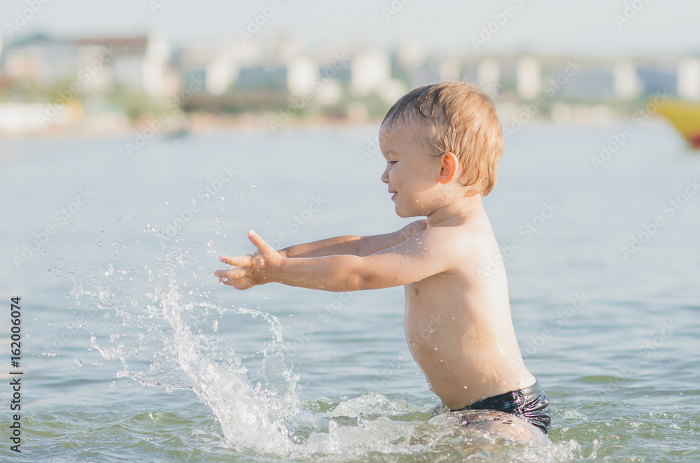 Fototapeta premium Little boy swimming in sea